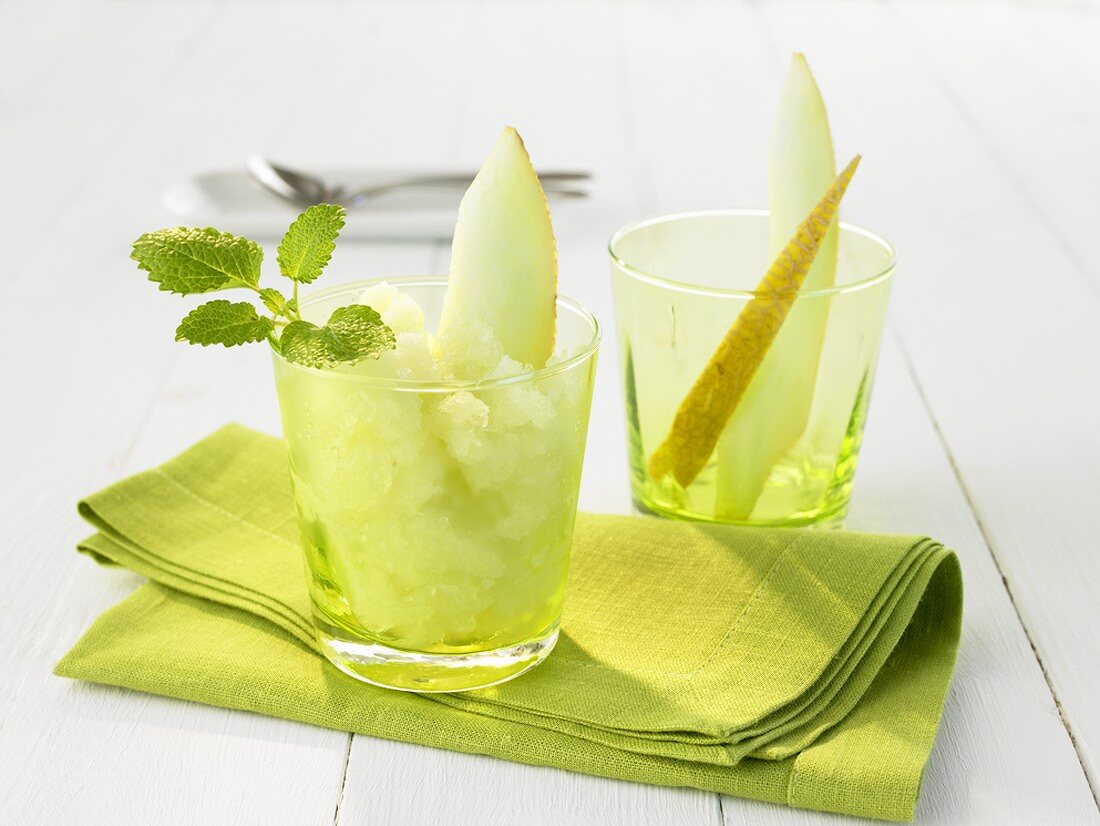 Melon sorbet with melon wedge and mint leaves