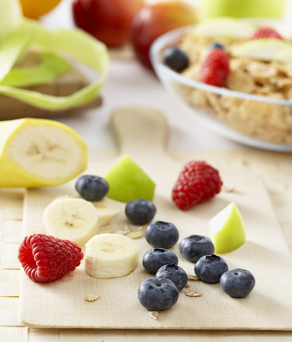 Breakfast ingredients: fruit, berries and cornflakes