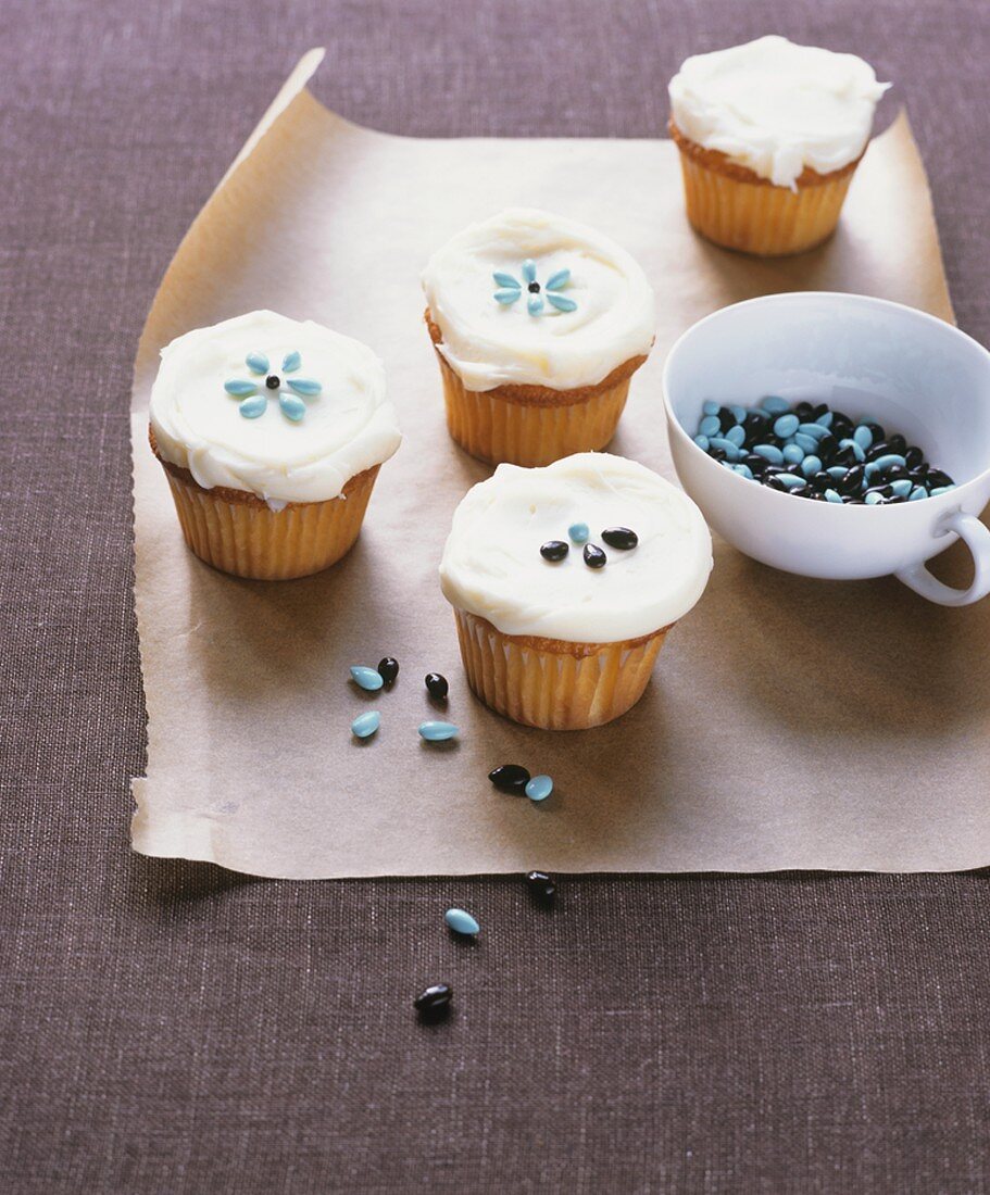Cupcakes with white icing and sugar decorations
