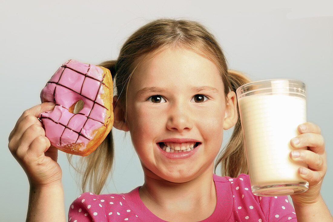 Girl with doughnut and milk