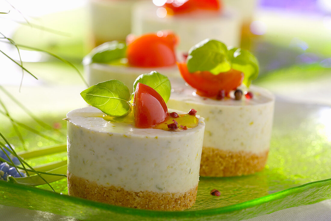 Garlic cheesecakes garnished with basil and tomato
