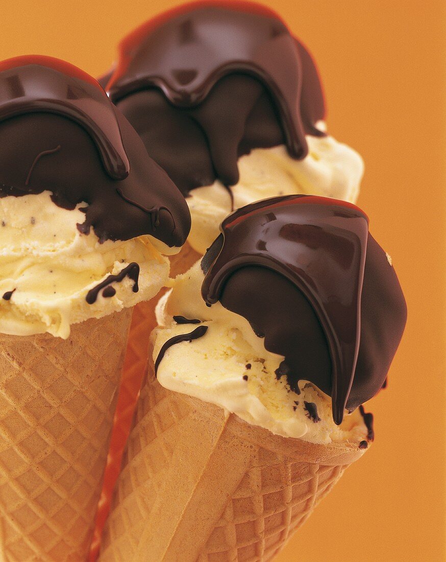 Vanilla ice cream with chocolate topping in ice cream cones