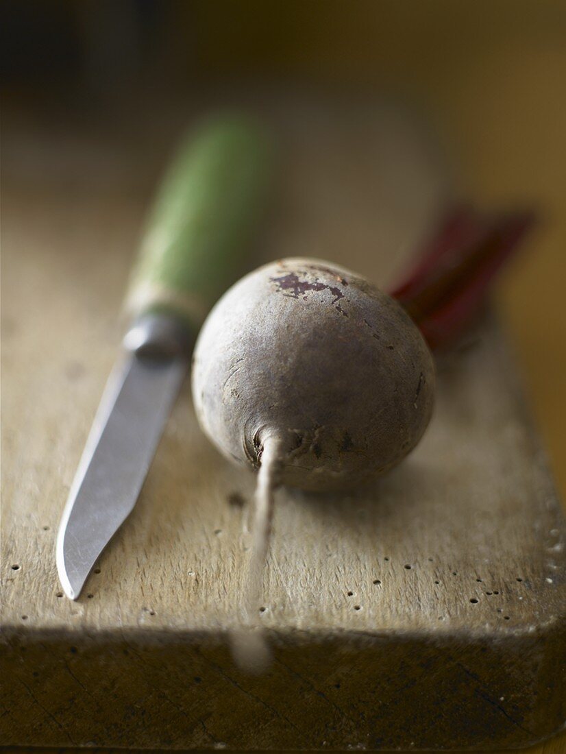 Beetroot and knife on wooden board