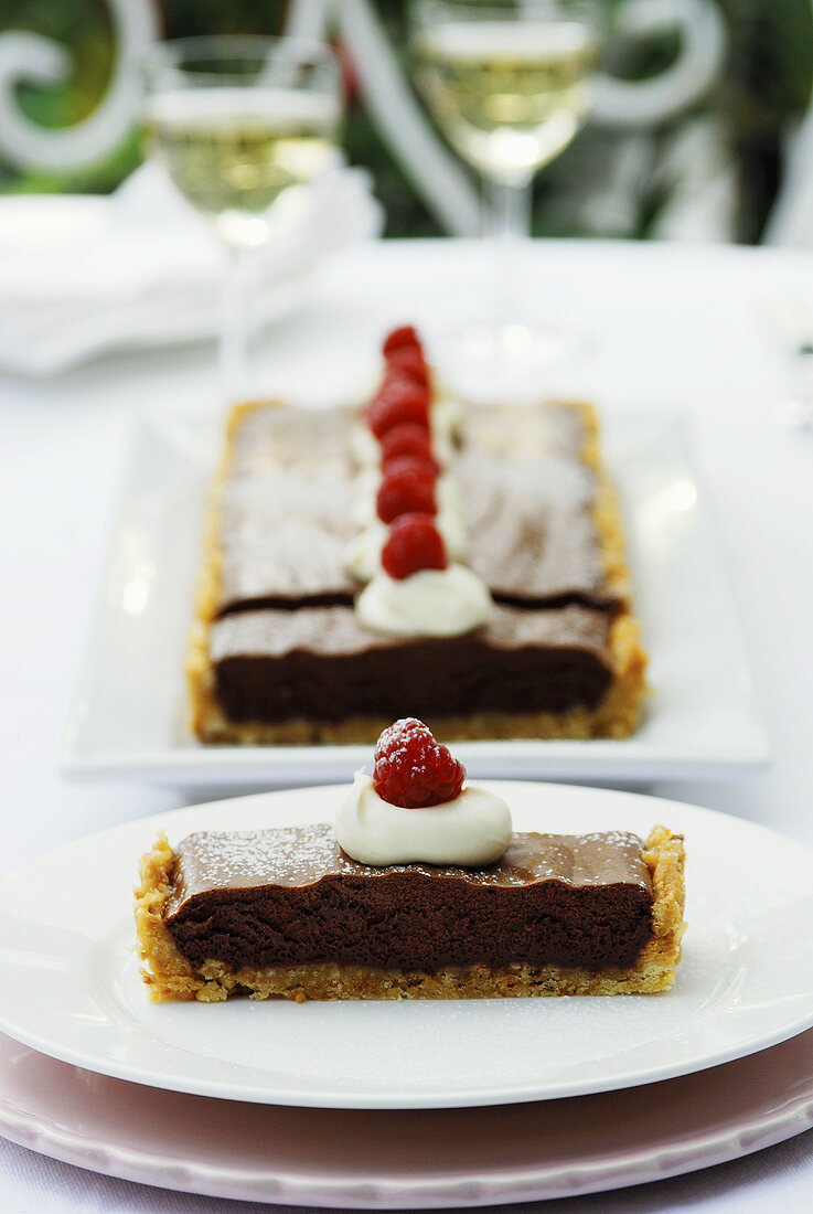 Chocolate tart with cream and raspberries