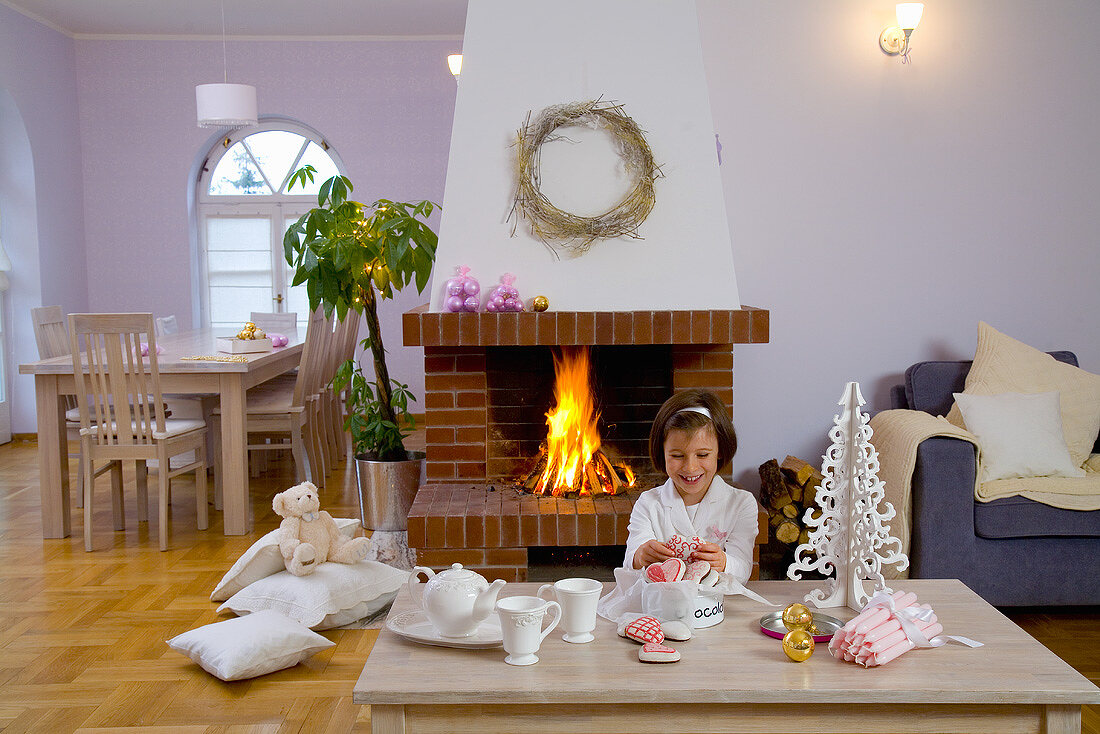 Girl with ginger biscuits and Christmas decorations