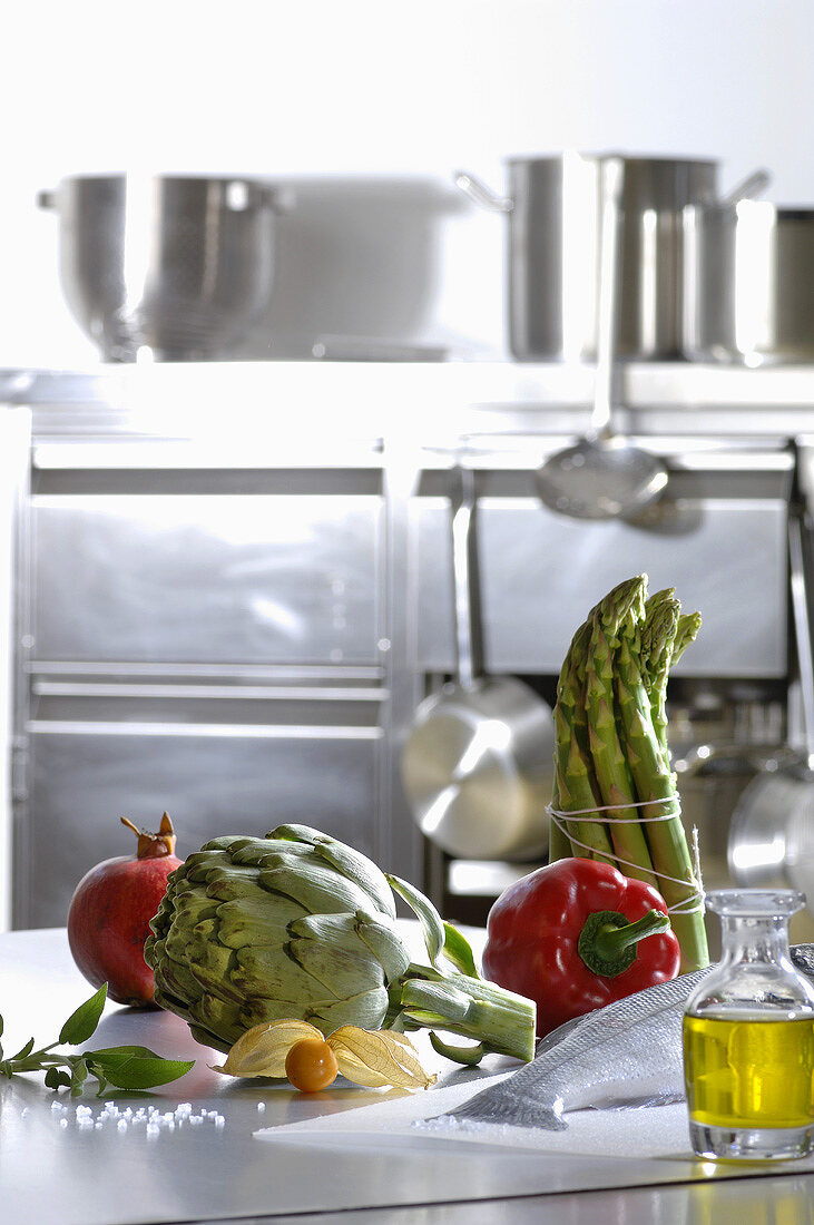 Fresh vegetables, fish and olive oil in a kitchen