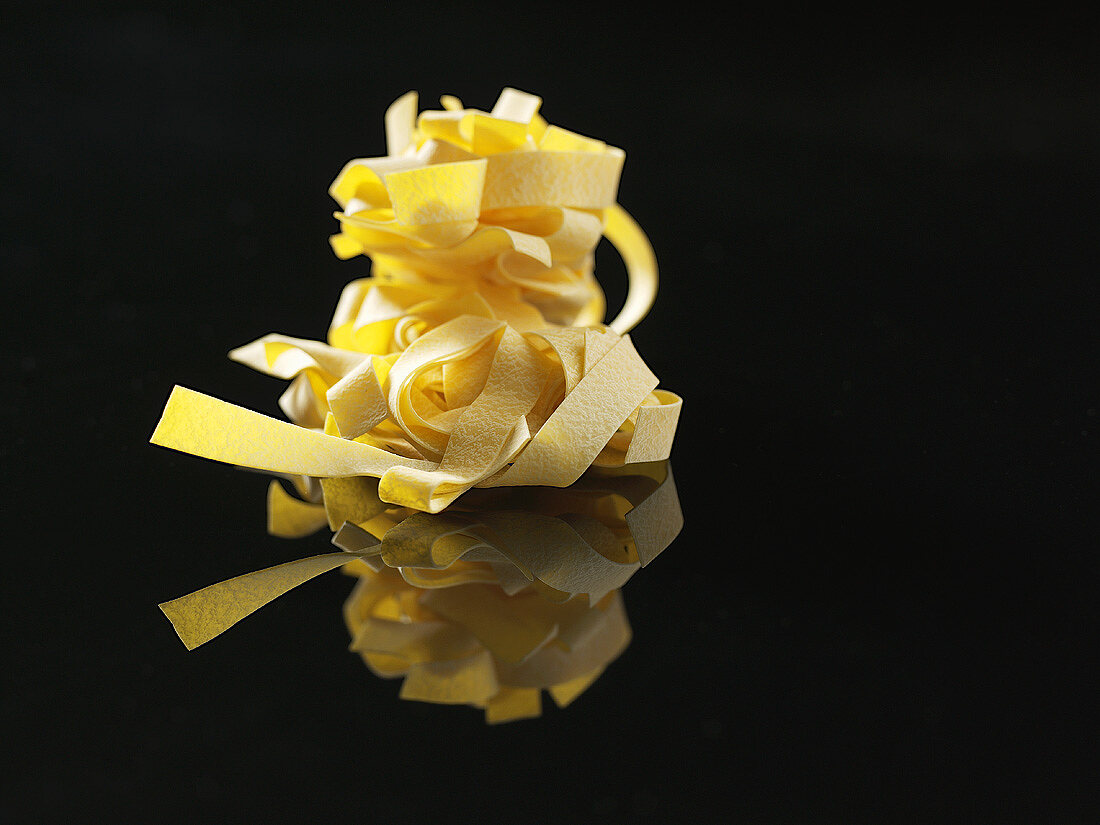 Fettuccine against a black background