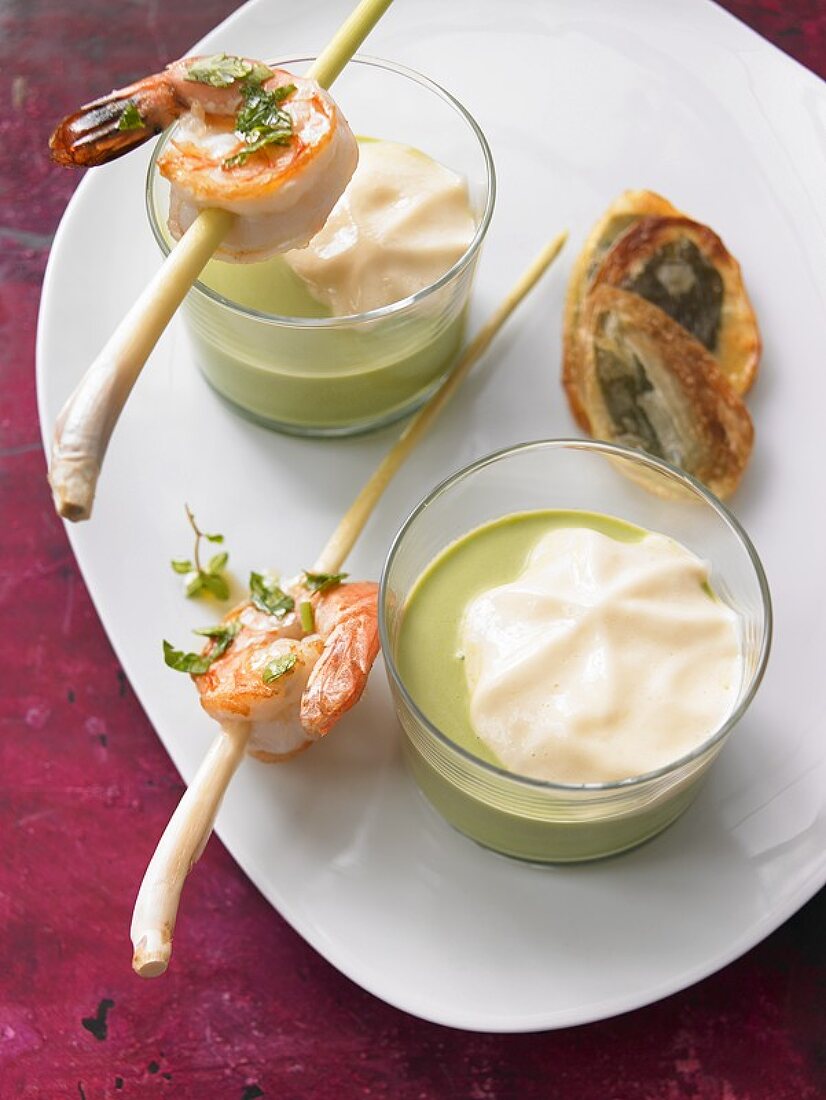 Ramsons (wild garlic) foam soup with prawns on lemon grass skewers