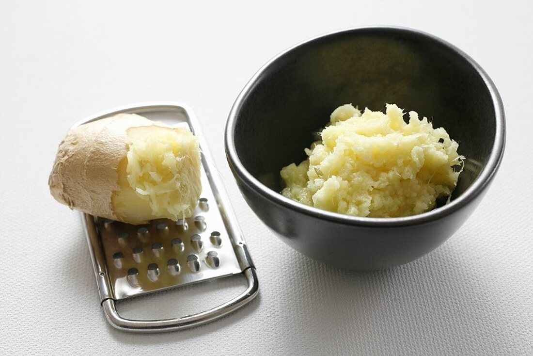 Ginger root on a grater and grated ginger