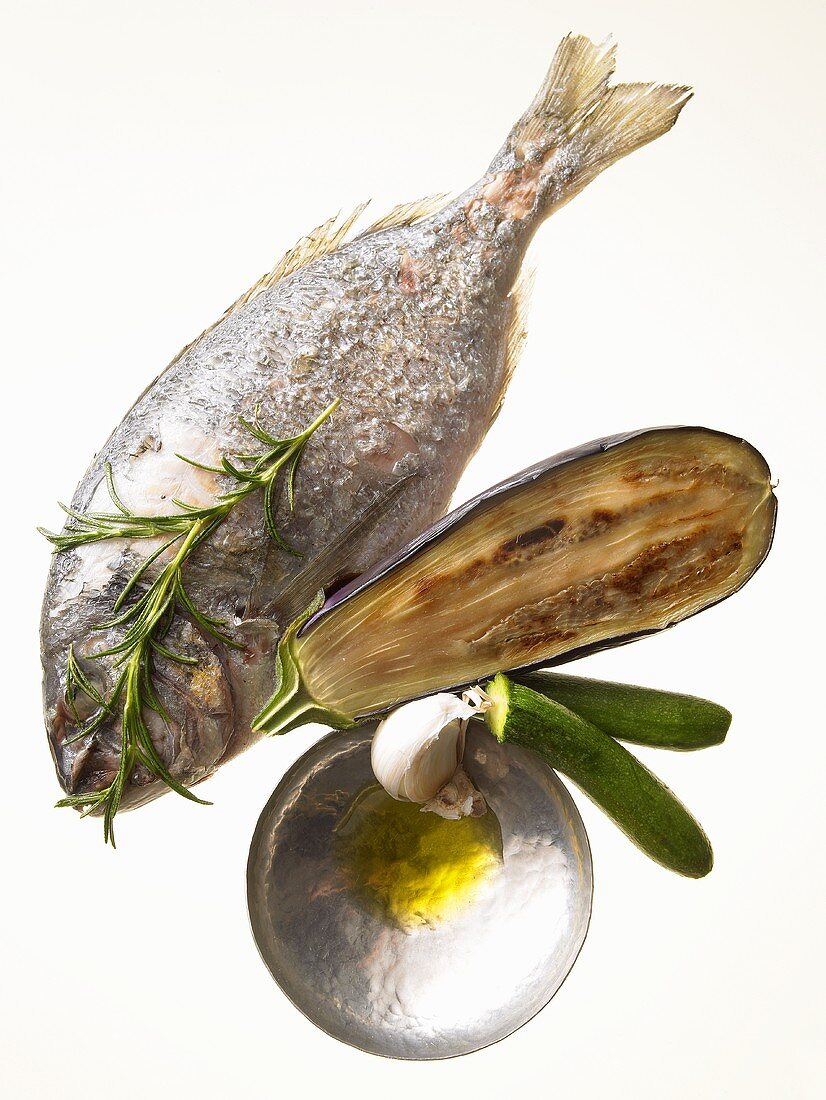 Mediterranean diet: sea bream, aubergine, courgette, olive oil