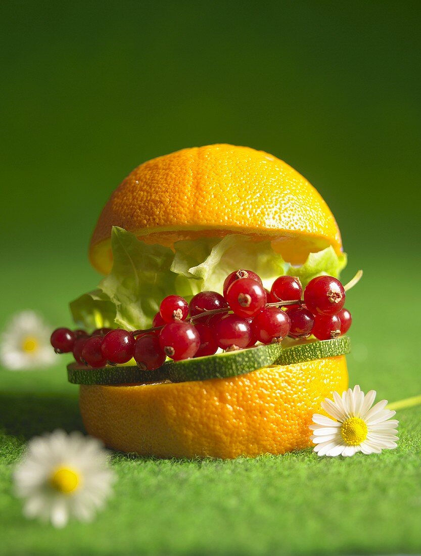Healthy burger: courgettes, redcurrants, lettuce in an orange