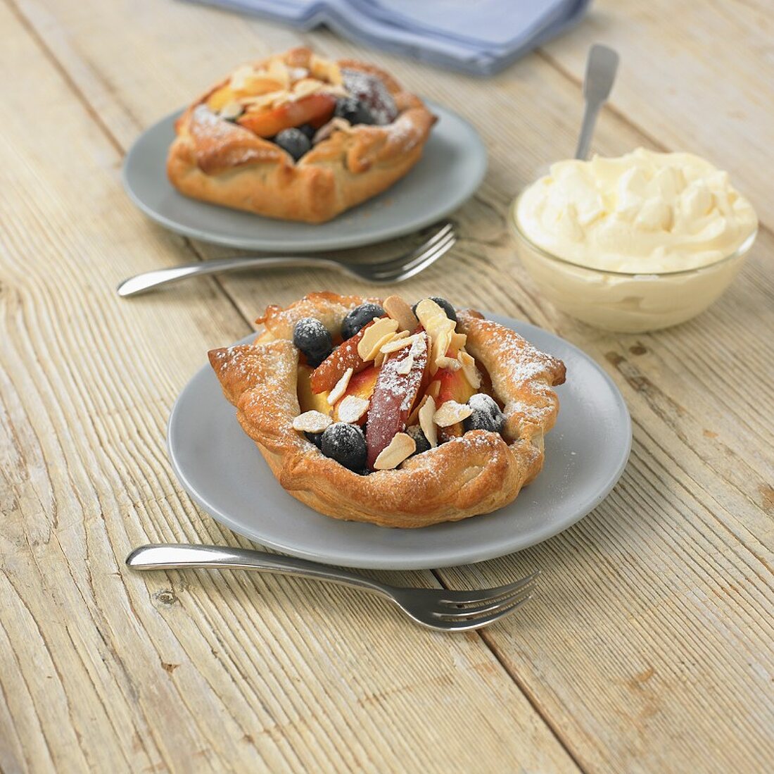 Peach wedges and blueberries in puff pastry shells