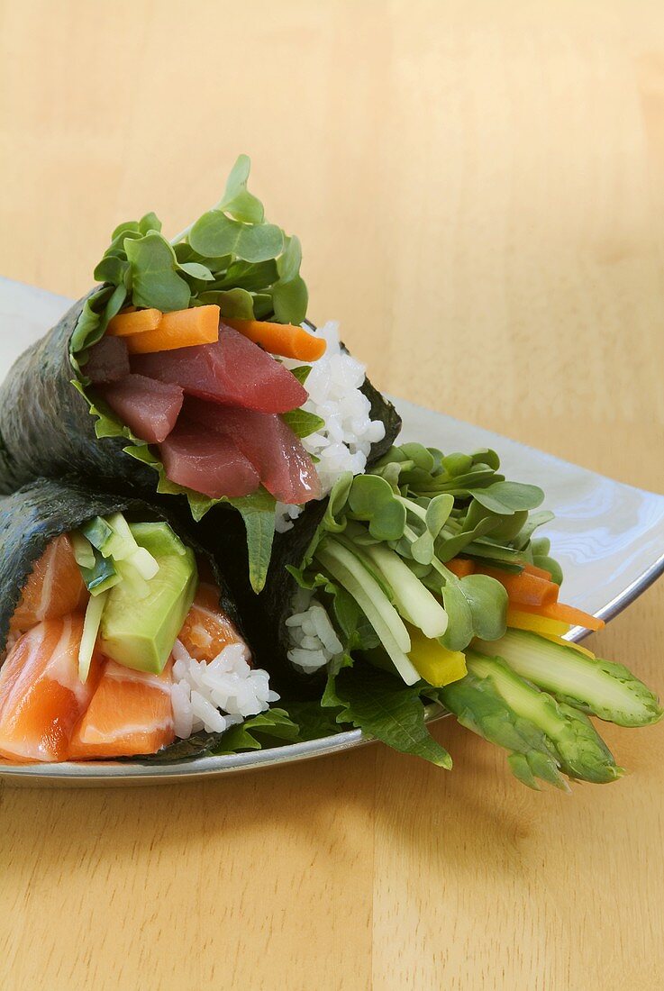 Temaki sushi with salmon, tuna and vegetables