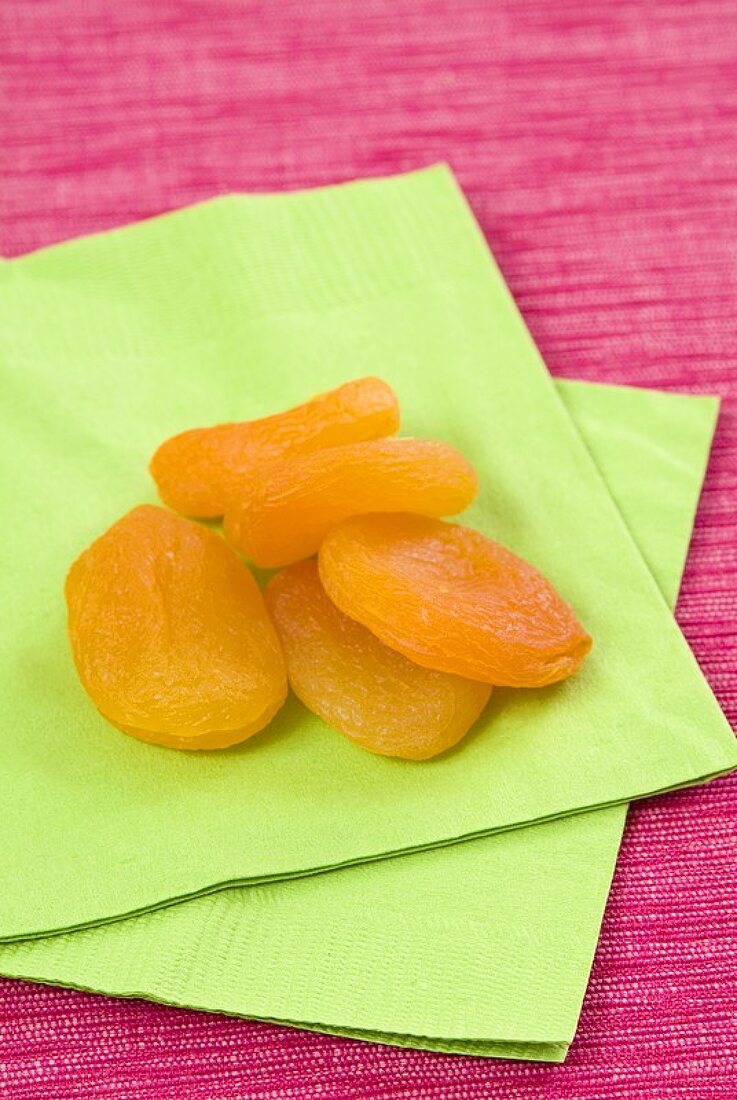 Dried apricots on green napkins
