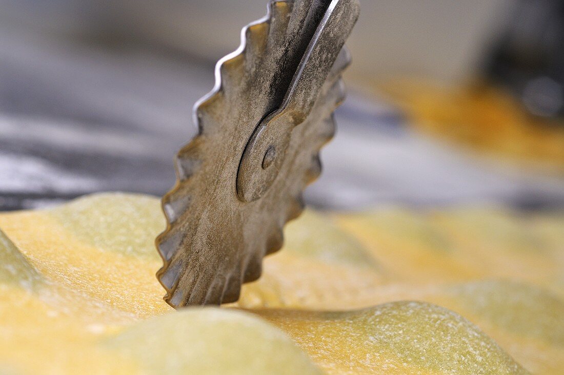Cutting out ravioli with a pastry wheel (close-up)