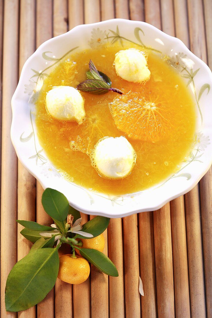 Orange soup with snow dumplings