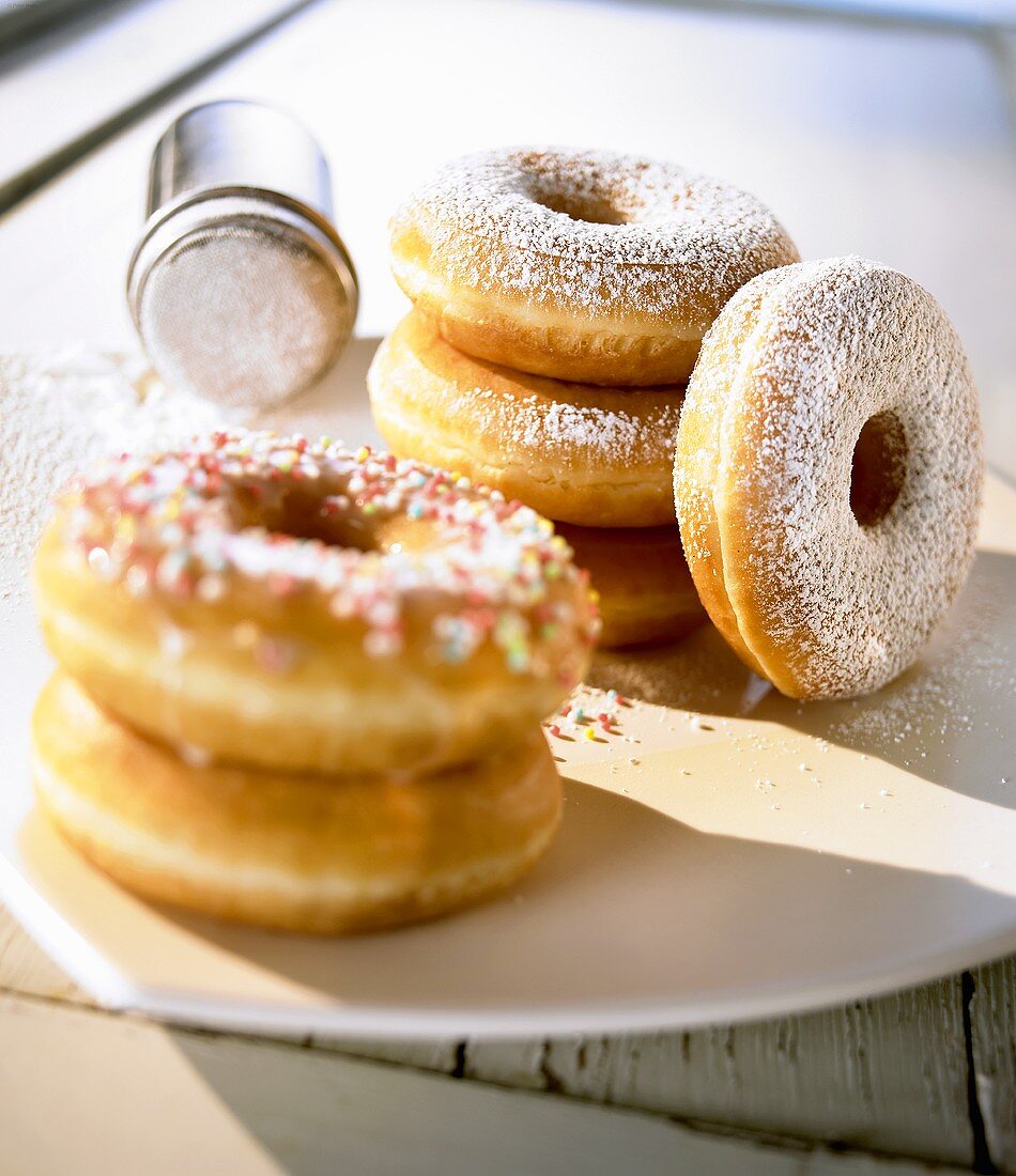 Doughnuts with sprinkles and with icing sugar