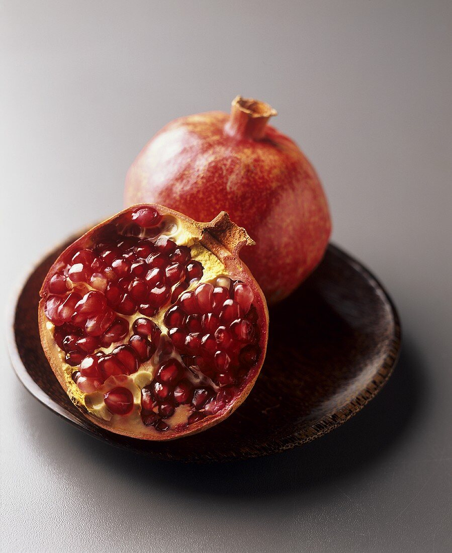 Half a pomegranate and a whole pomegranate
