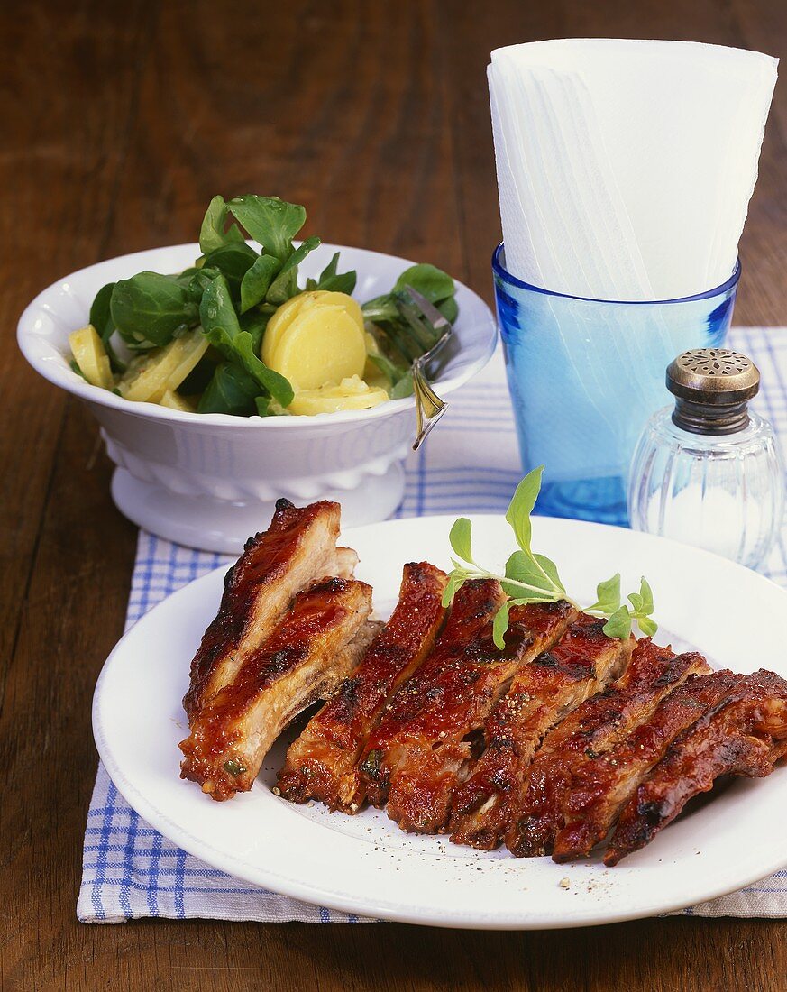 Spicy grilled pork ribs and potato salad with corn salad
