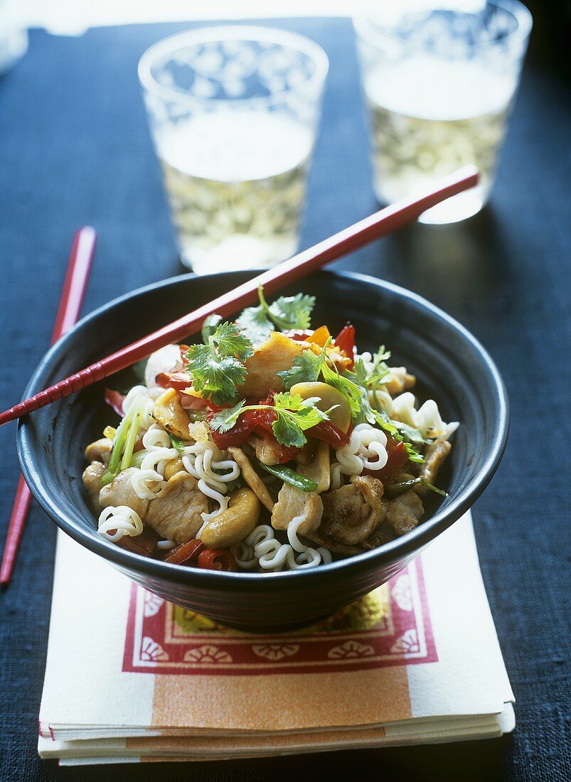Asian noodles with pork, cashew nuts and coriander