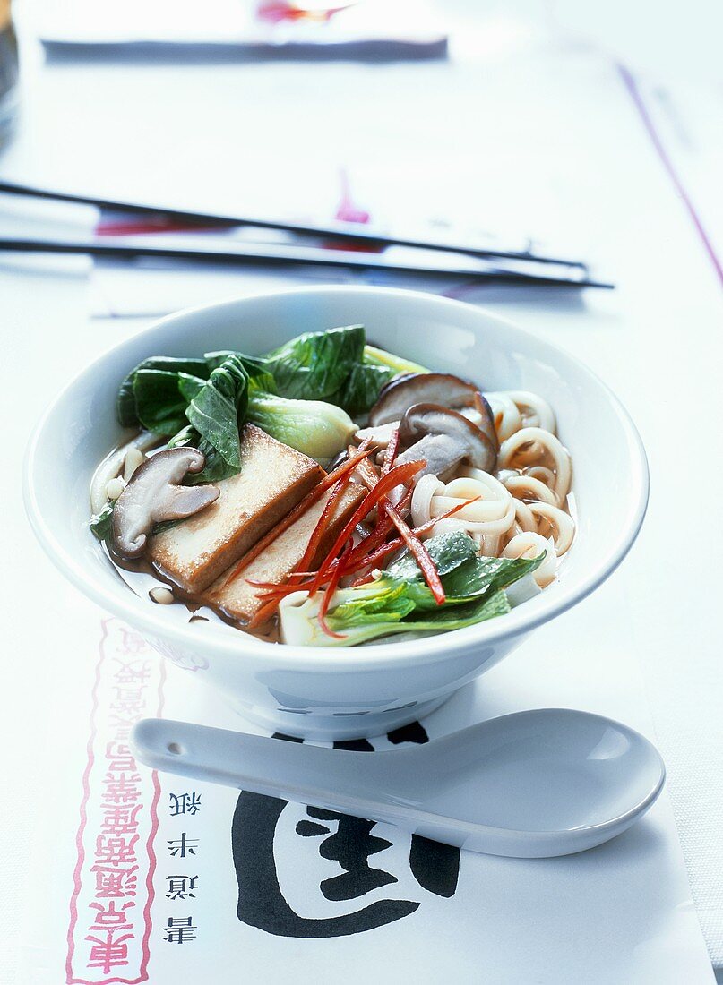 Asian noodle soup with tofu, pak choi and mushrooms