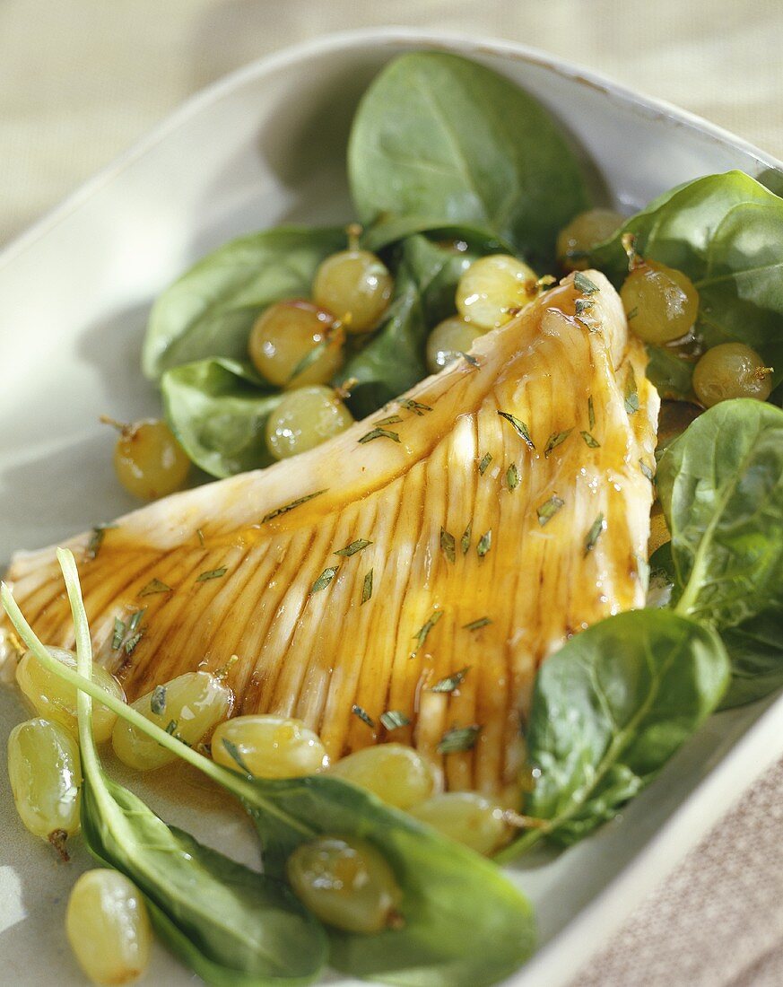 Skate wing with spinach and grape salad