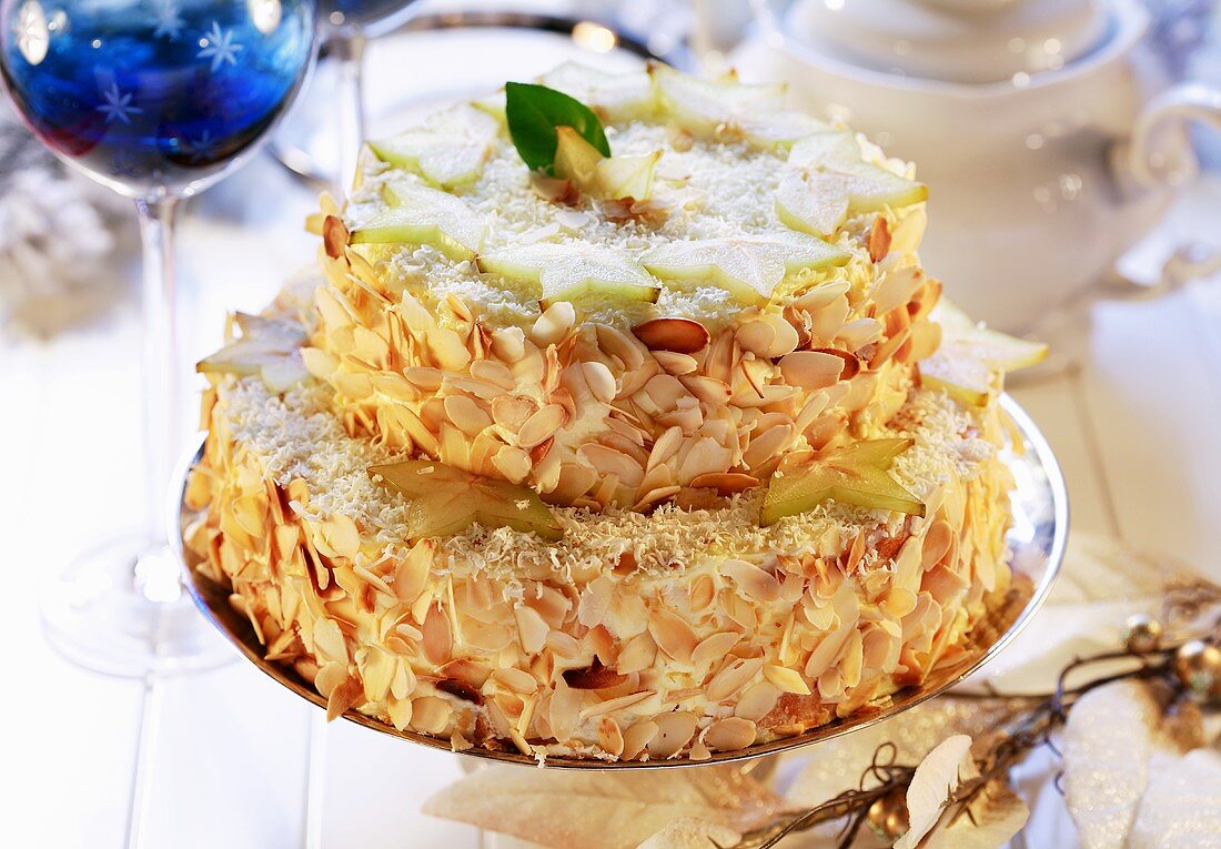 Two-tiered almond cake with carambola slices