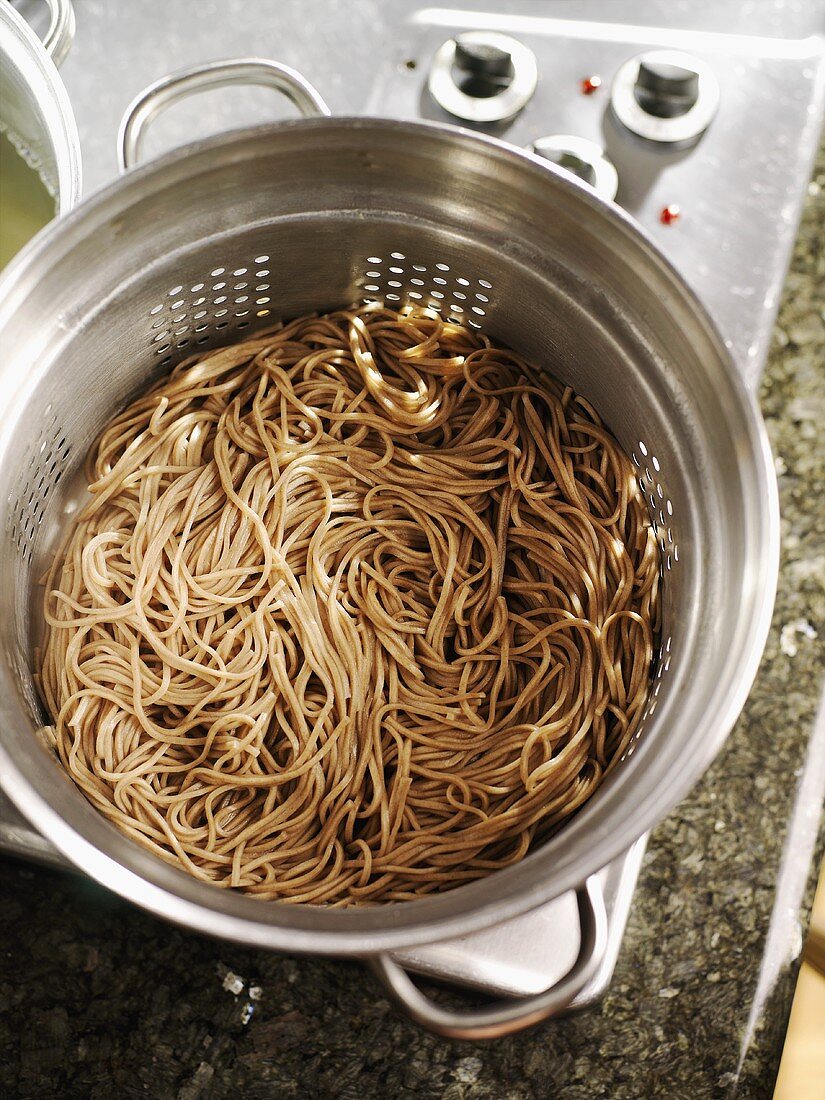 Soba noodles in a colander