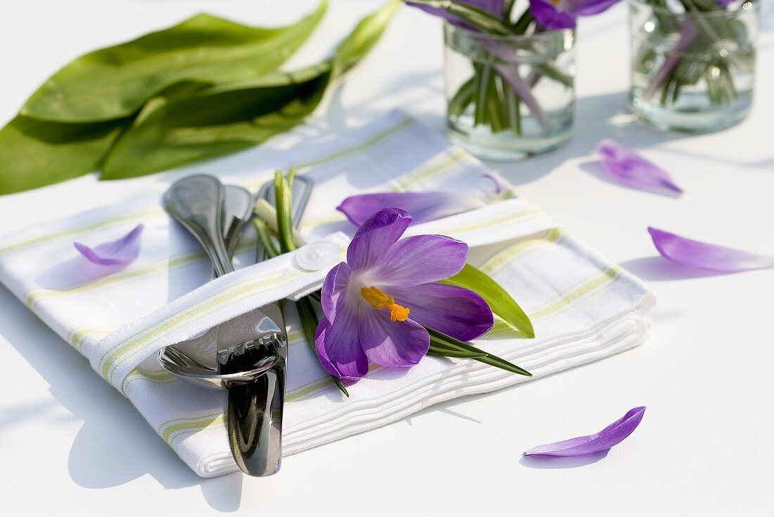 Crocuses and cutlery on a napkin