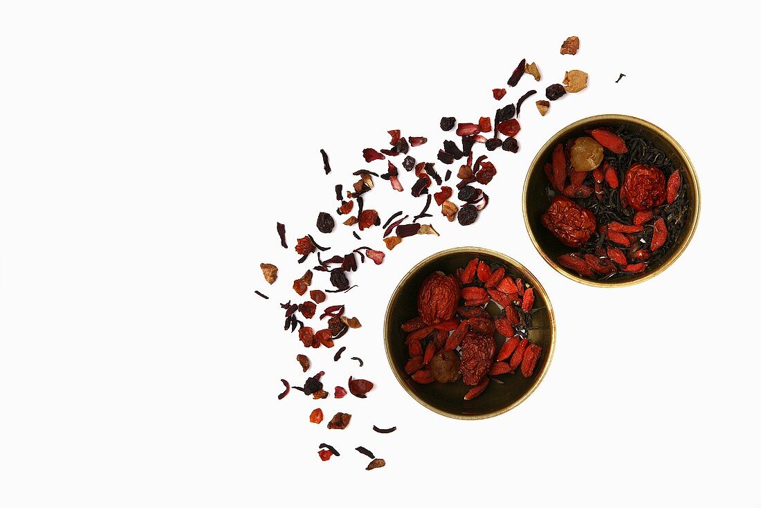 Dried tea leaves in and beside small bowls