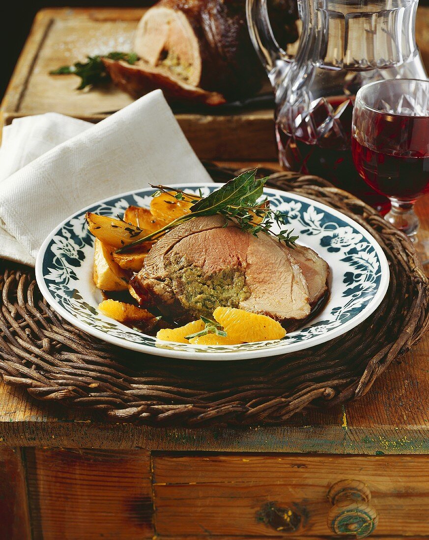 Roast lamb with herbs, orange segments & rosemary potatoes