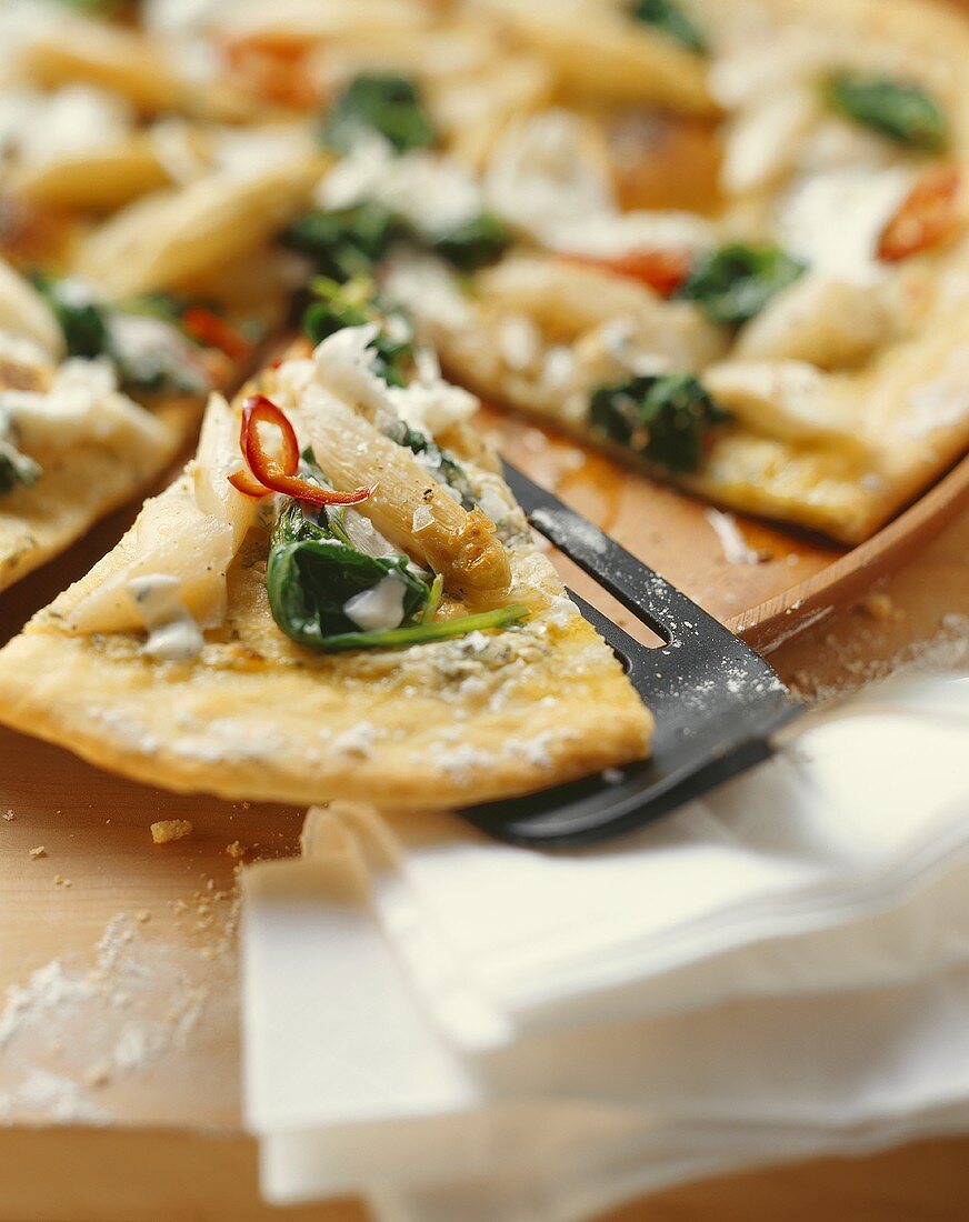 Pizza topped with asparagus, ramsons, spinach & soft cheese