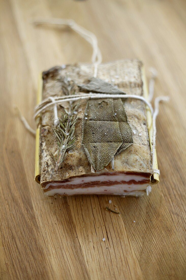 Herb-cured bacon with a piece removed