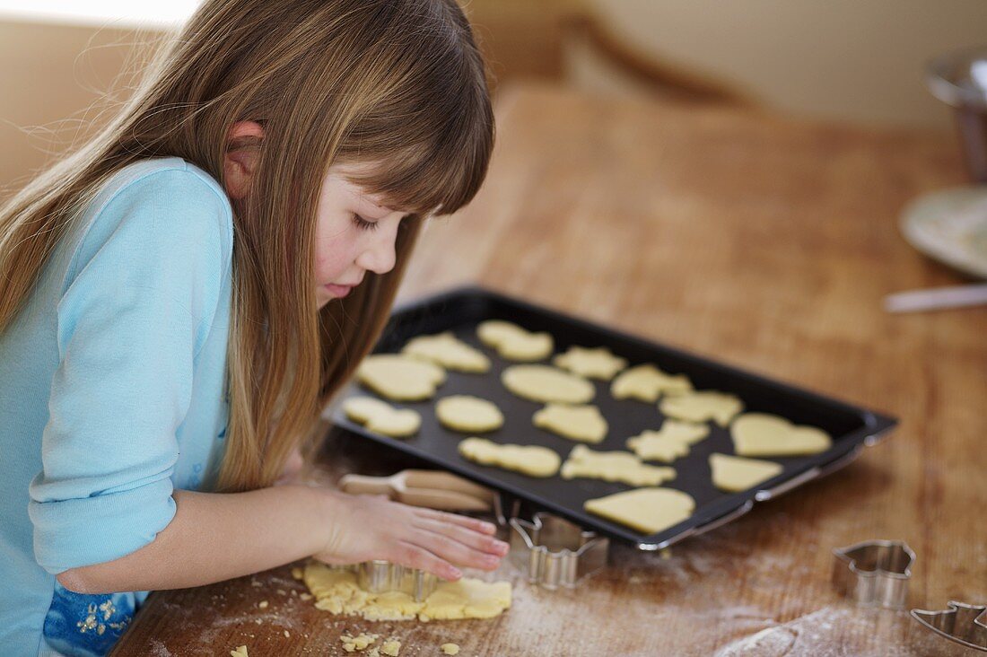 Girl cutting out biscuits