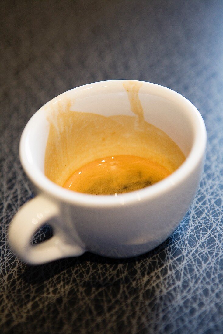 A half-full espresso cup