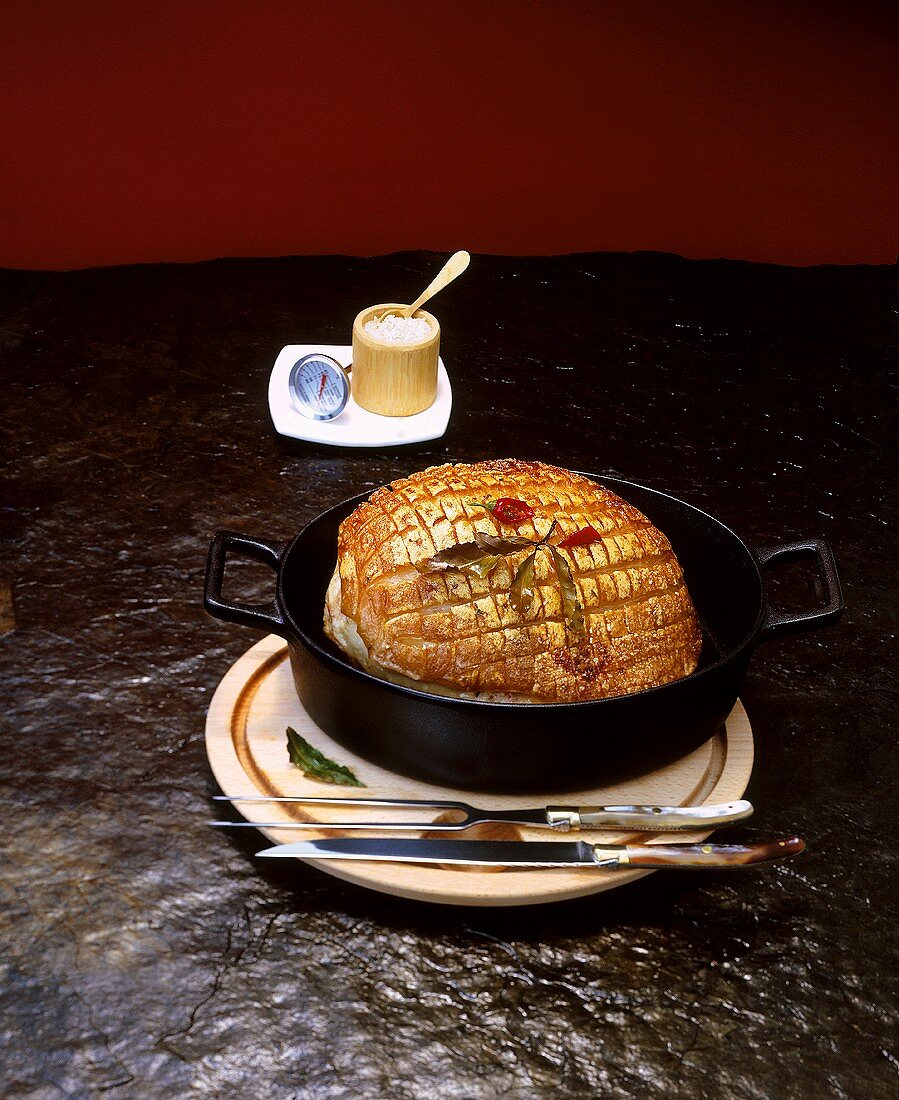 Roast pork with crackling in a roasting dish