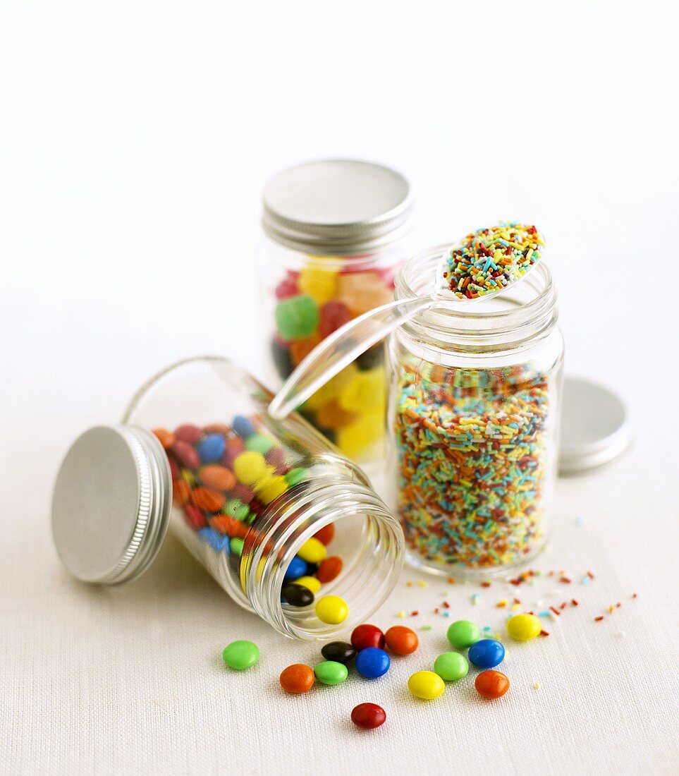 Chocolate beans, sprinkles and sweets in jars