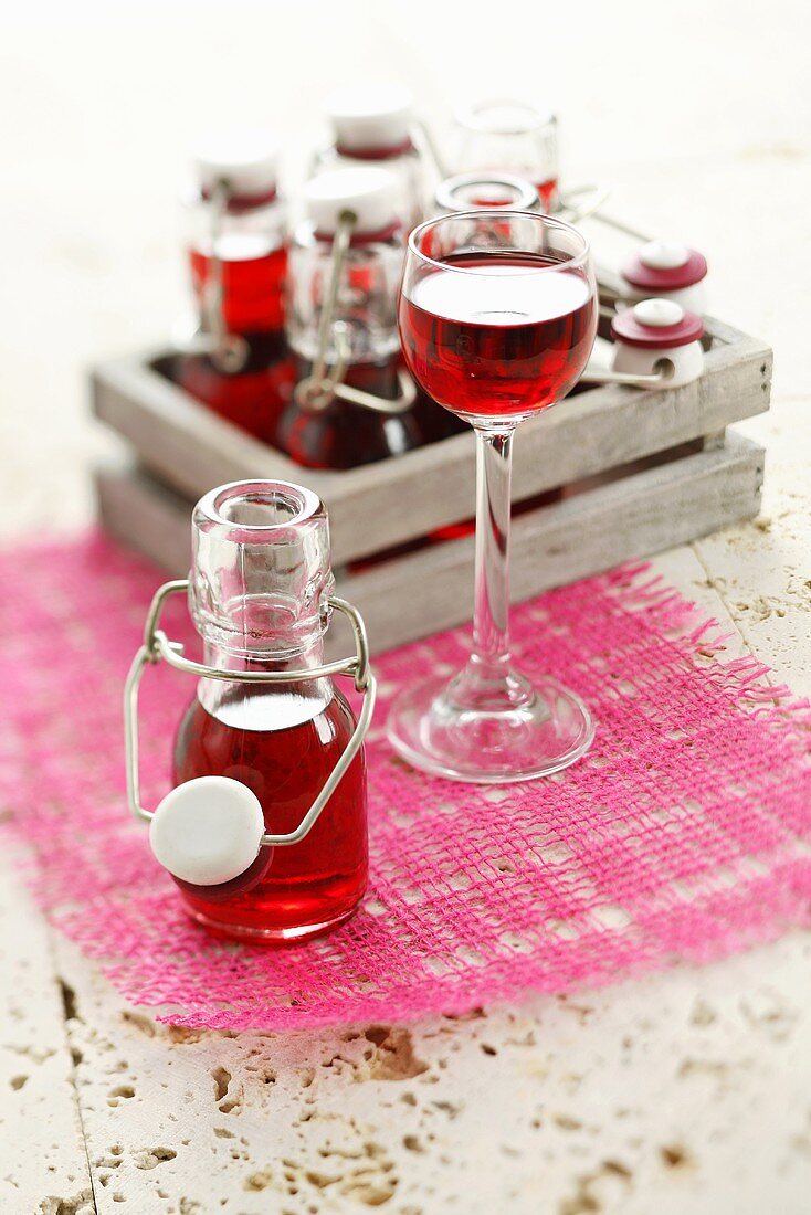 Cherry liqueur in small flip-top bottles and in glass