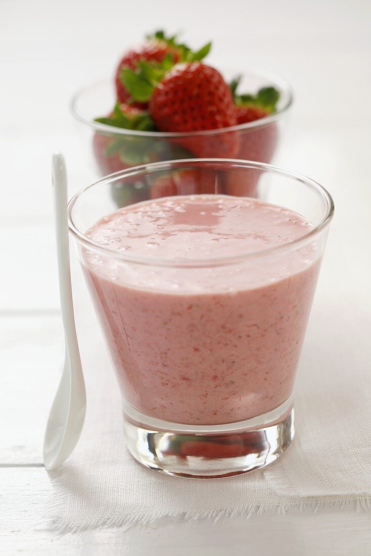 Strawberry smoothie and fresh strawberries