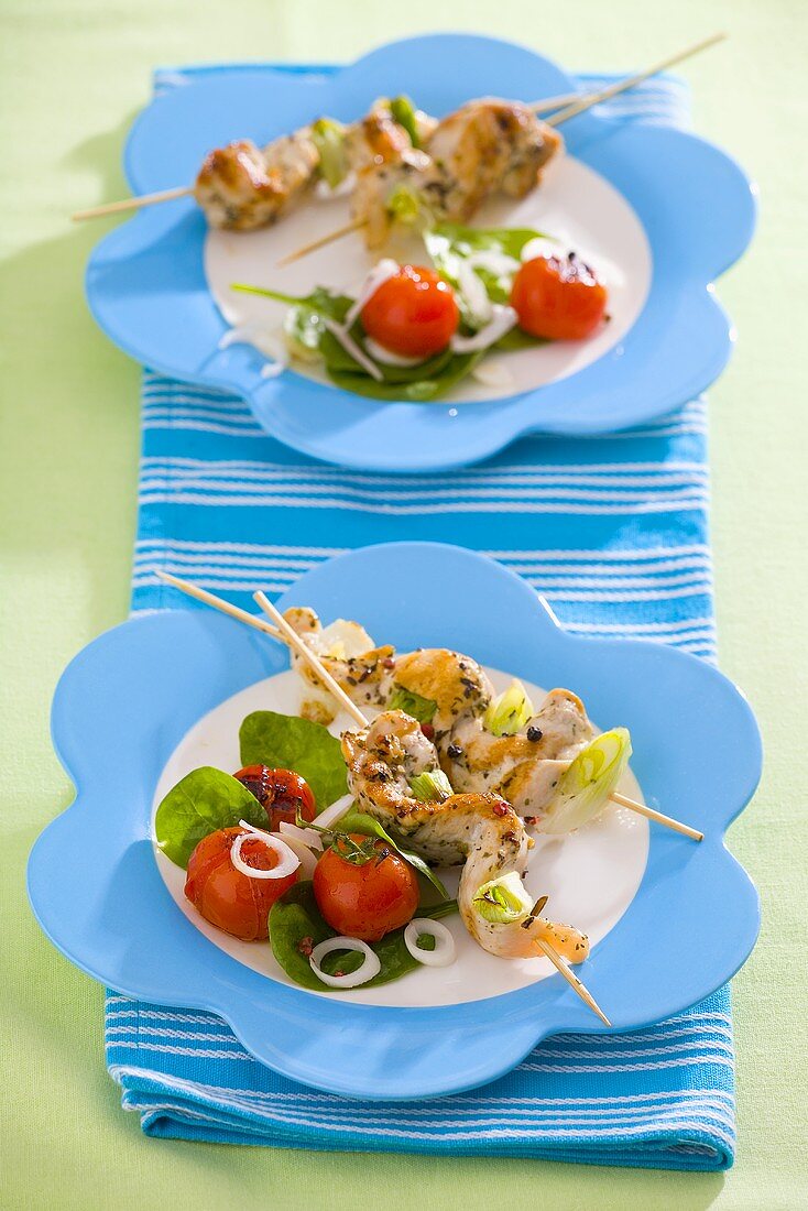 Grilled chicken kebabs with tomato salad
