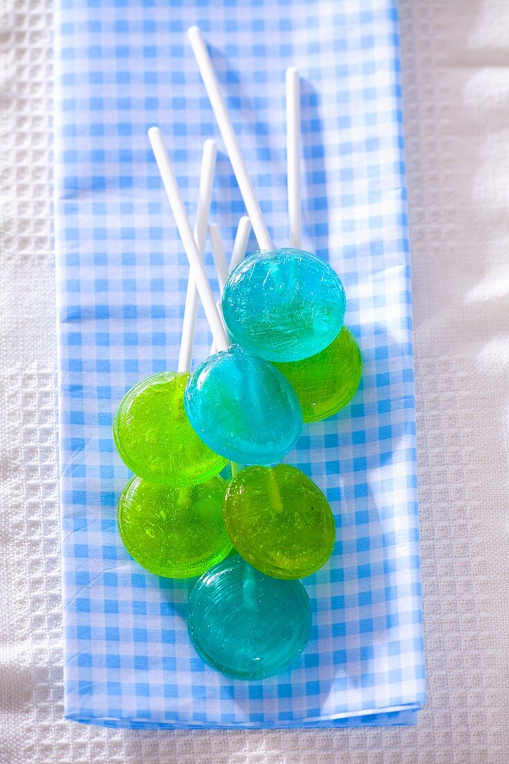 Blue and green lollipops on checked cloth