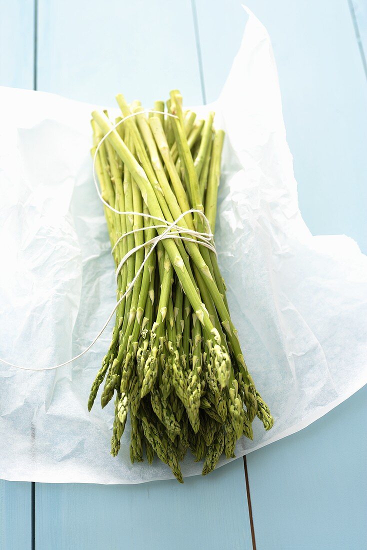 A bundle of wild asparagus on paper