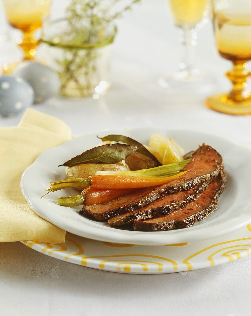 Roast beef with carrots, spring onions and potatoes