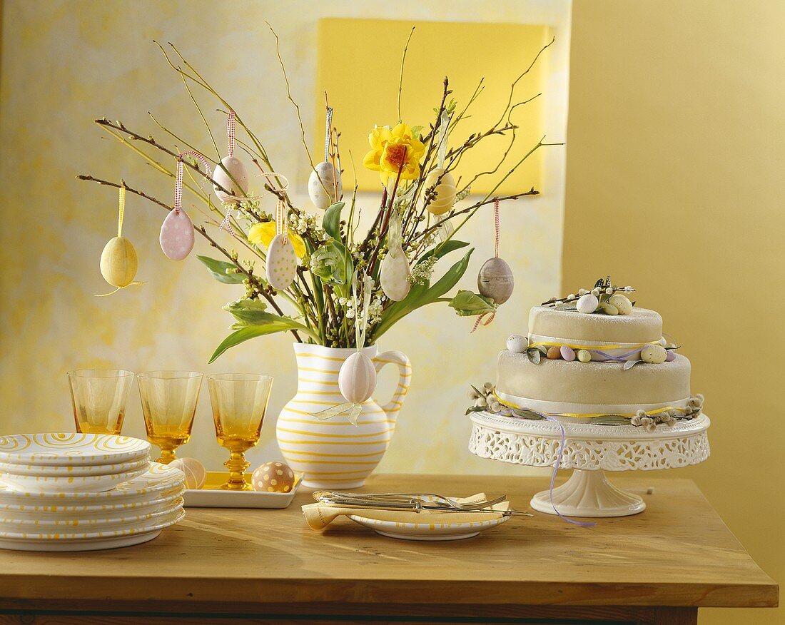 Tiered cake & jug of flowers with biscuits on Easter buffet