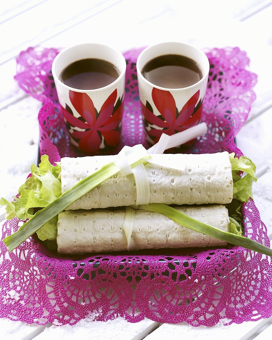 Chicken salad wraps and two cups of coffee