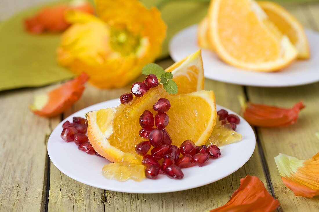Orange wedges with pomegranate seeds and orange jelly