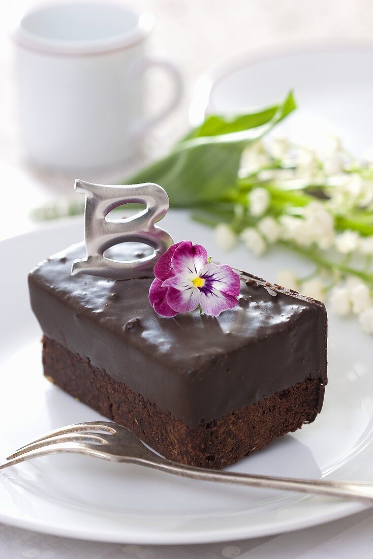Chocolate slice decorated with horned violet