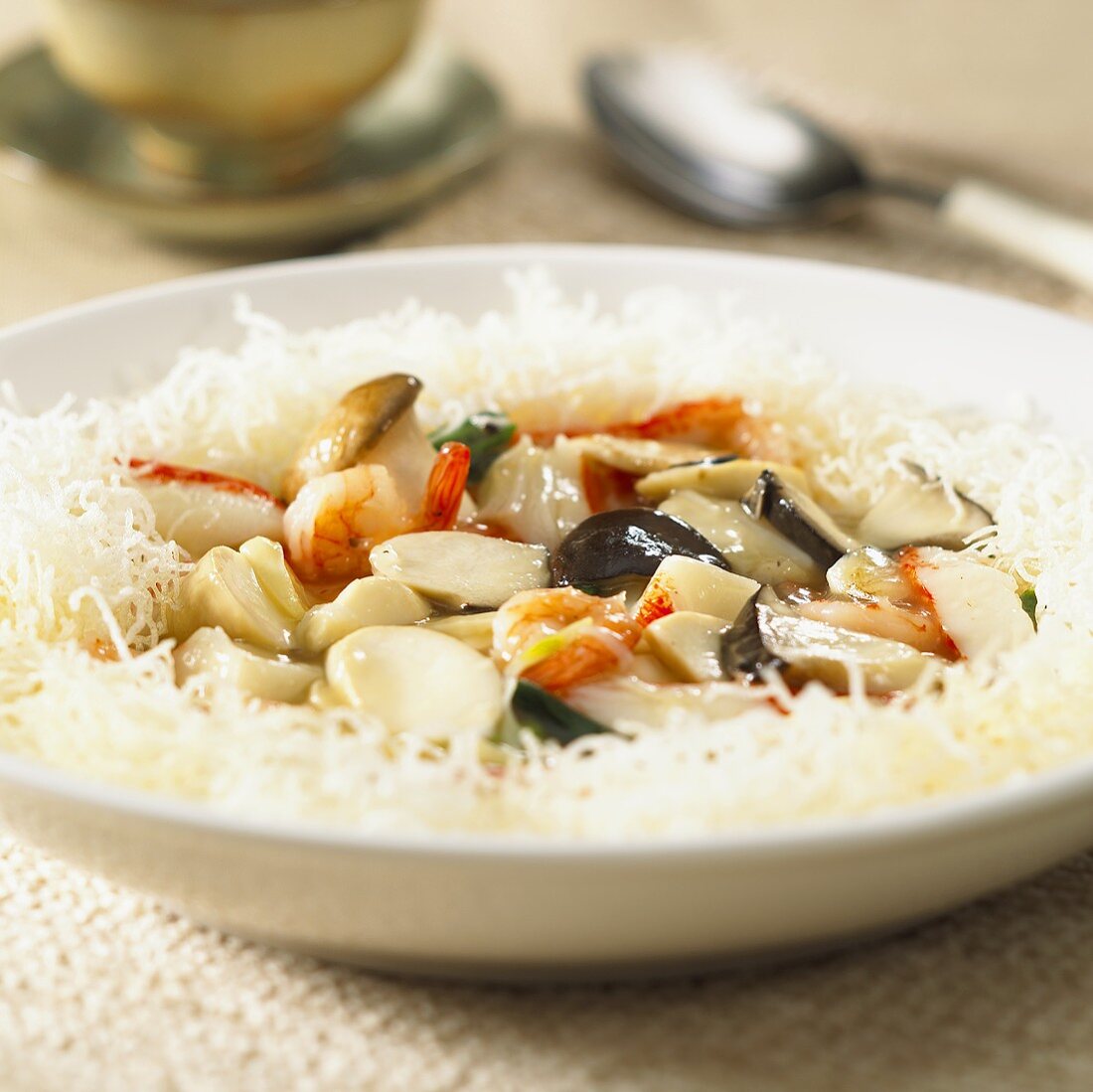 Seafood and mushroom stir-fry on rice noodles