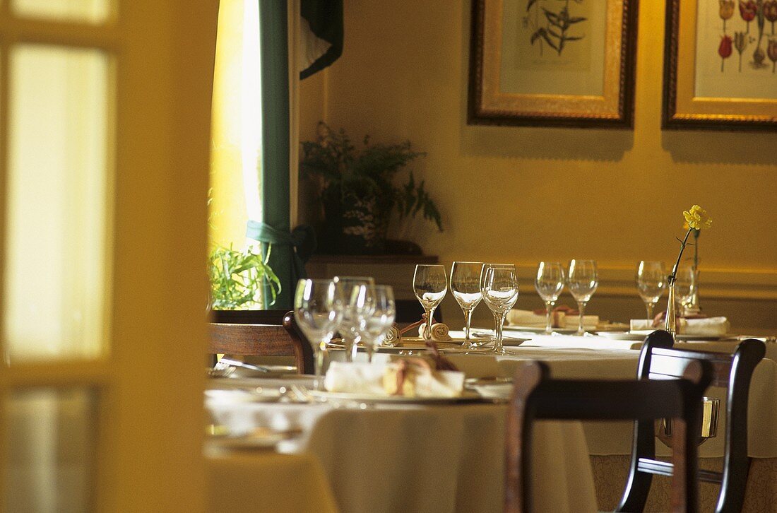 Laid tables with wine glasses in a restaurant