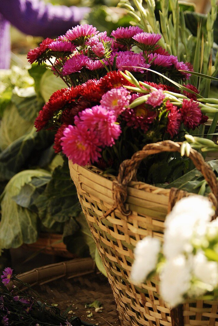 Basket of flowers and vegetables on a market stall